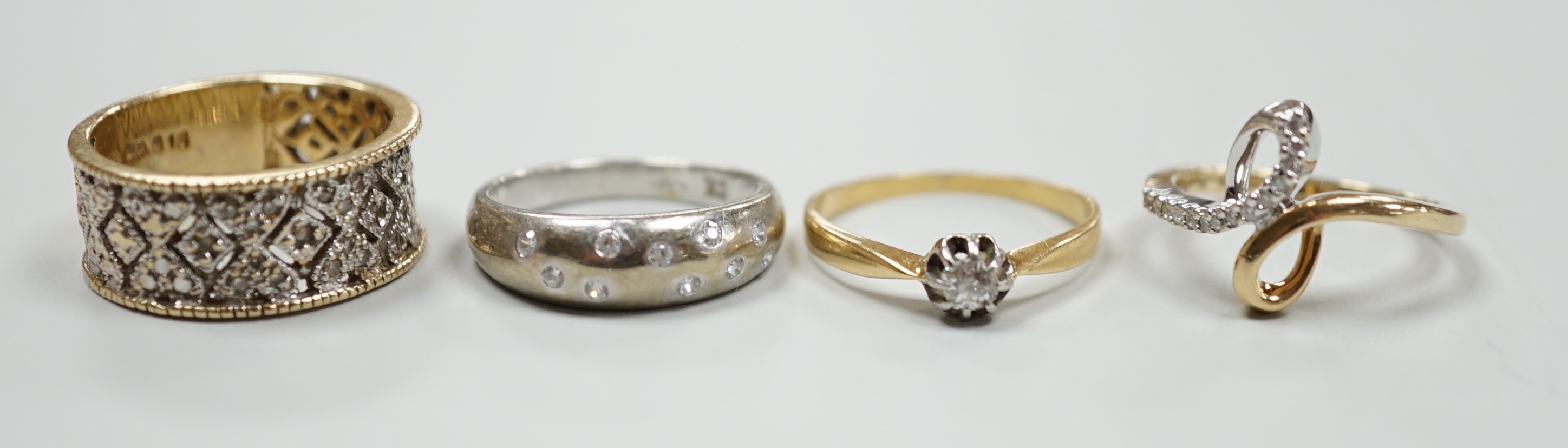 Three modern 9ct gold and diamond chip set rings and a yellow metal and solitaire diamond set ring, gross weight 12.4 grams.